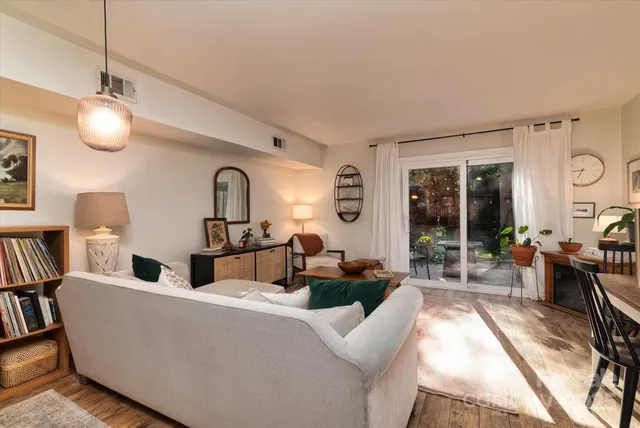 a living room with furniture a large window and flat screen tv