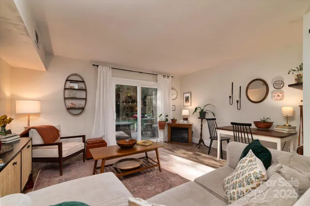 a living room with furniture a rug and a window