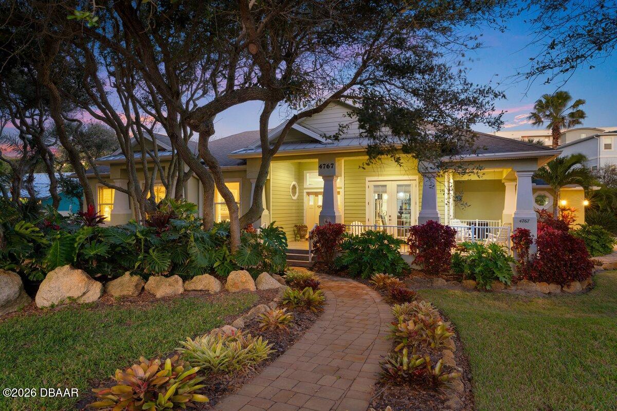 4767 Riverglen Boulevard Ponce Inlet, FL 32127 - Photo 1 of 60 a front view of a house with garden