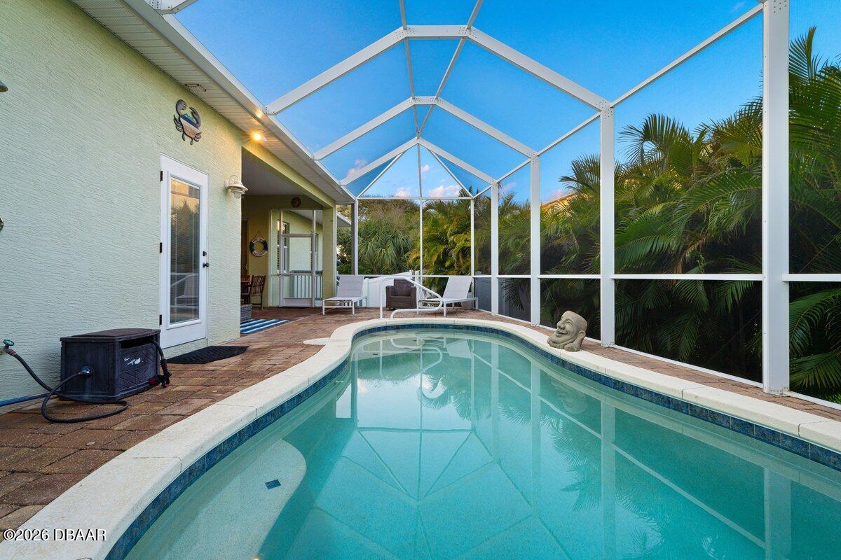 4767 Riverglen Boulevard Ponce Inlet, FL 32127 - Photo 24 of 60 a view of a backyard with a patio and wooden floor