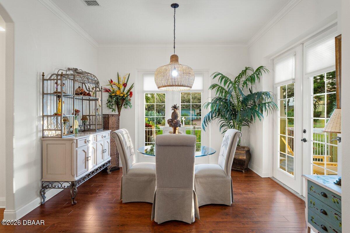 4767 Riverglen Boulevard Ponce Inlet, FL 32127 - Photo 29 of 60 a dining room with furniture potted plants and wooden floor