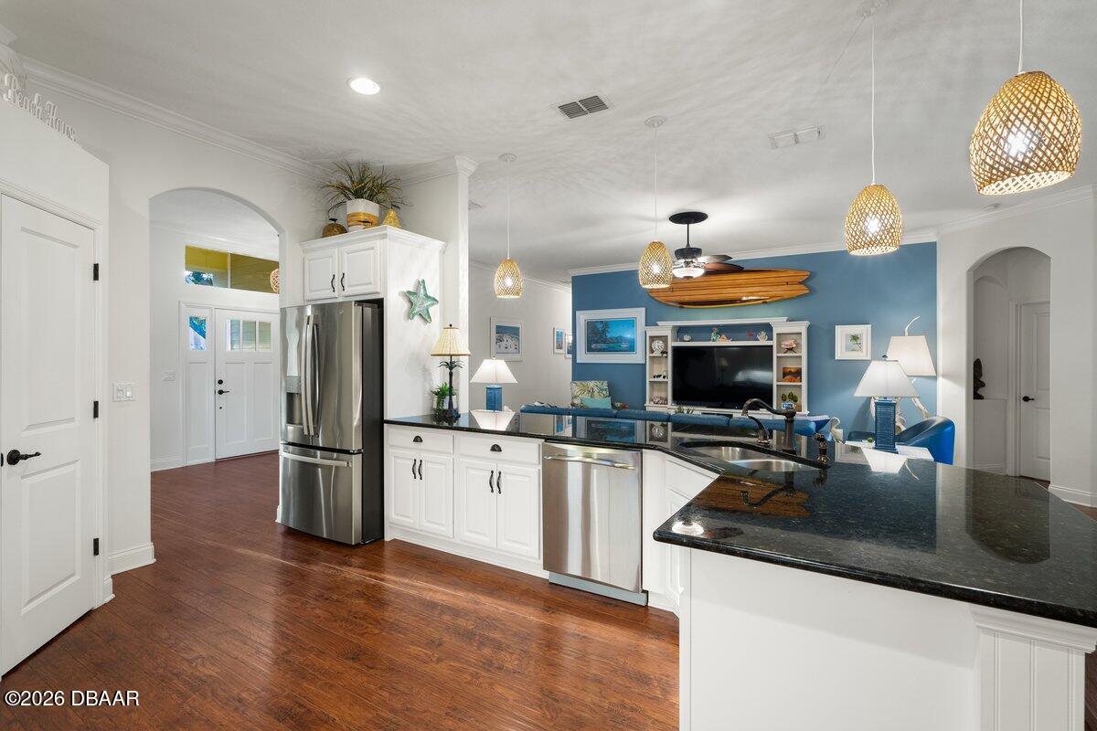 4767 Riverglen Boulevard Ponce Inlet, FL 32127 - Photo 34 of 60 a kitchen with stainless steel appliances granite countertop a refrigerator a stove top oven and sink