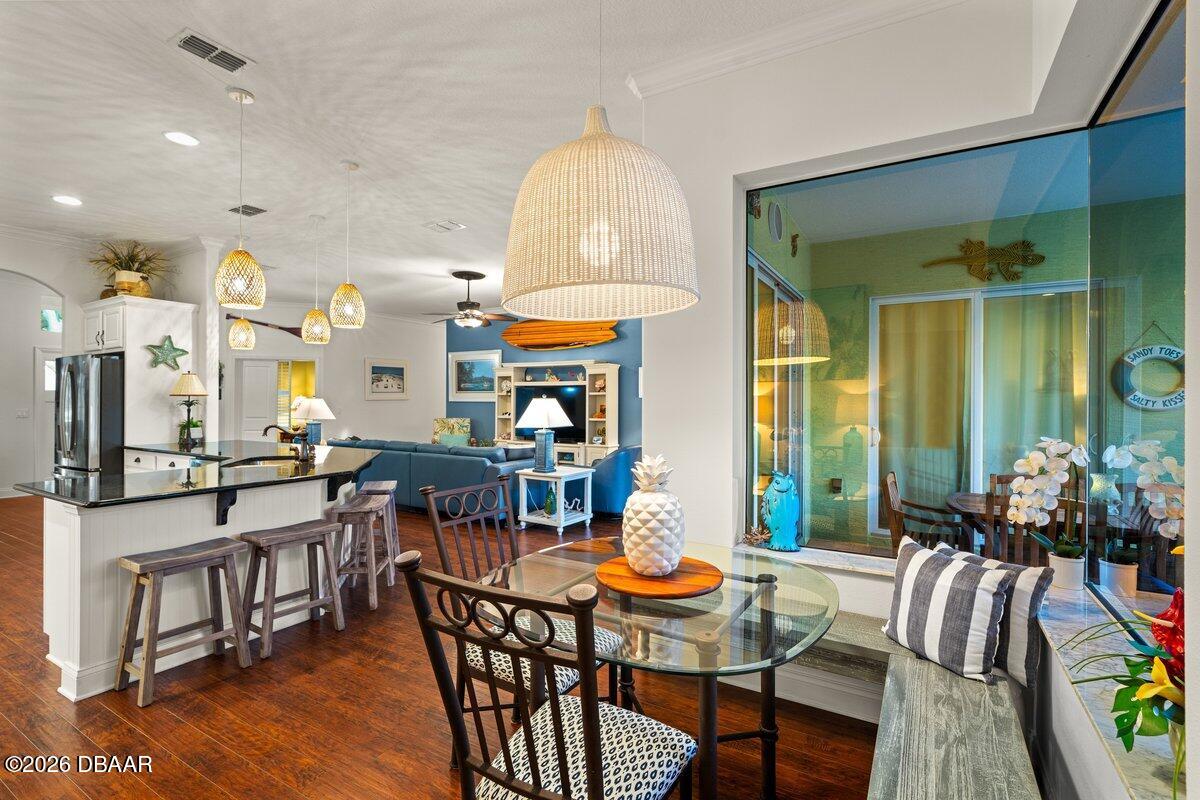 4767 Riverglen Boulevard Ponce Inlet, FL 32127 - Photo 36 of 60 a view of a dining room with furniture and wooden floor