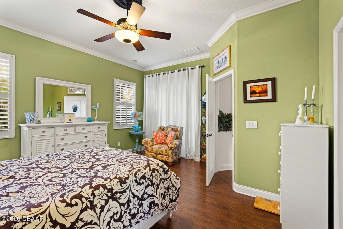 4767 Riverglen Boulevard Ponce Inlet, FL 32127 - Photo 45 of 60 a bedroom with a bed and a chandelier
