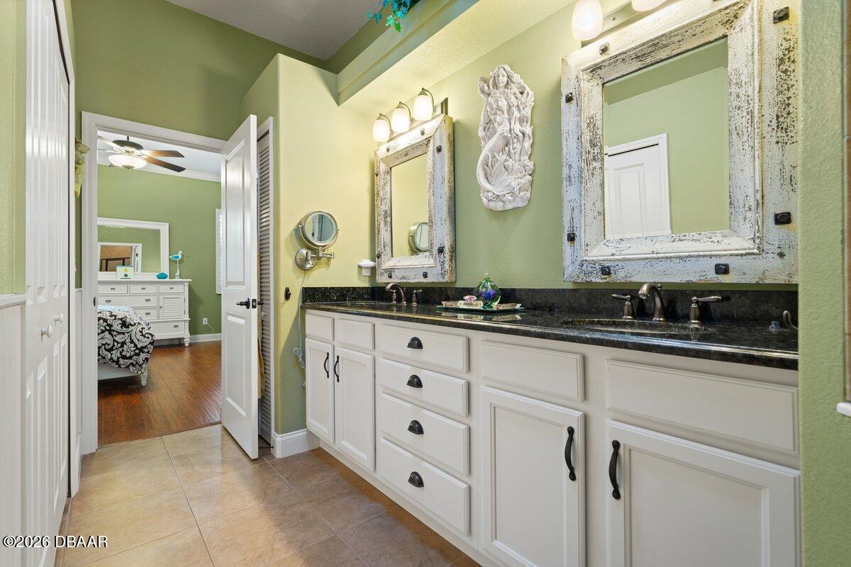 4767 Riverglen Boulevard Ponce Inlet, FL 32127 - Photo 48 of 60 a spacious bathroom with a double vanity sink and a mirror