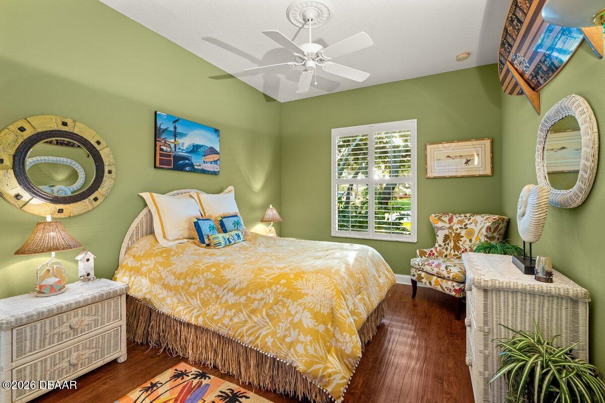 4767 Riverglen Boulevard Ponce Inlet, FL 32127 - Photo 50 of 60 a bedroom with a bed and a chandelier