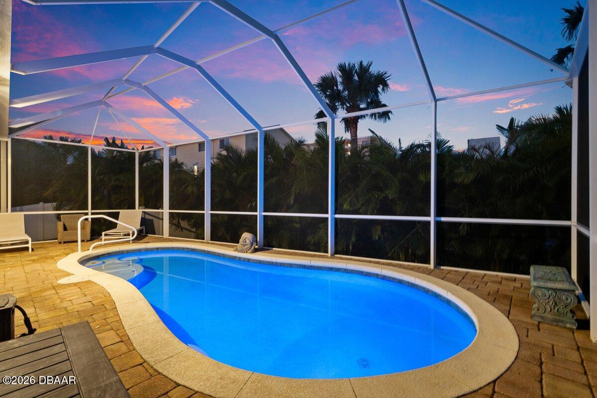 4767 Riverglen Boulevard Ponce Inlet, FL 32127 - Photo 5 of 60 a view of a swimming pool with a lounge chairs