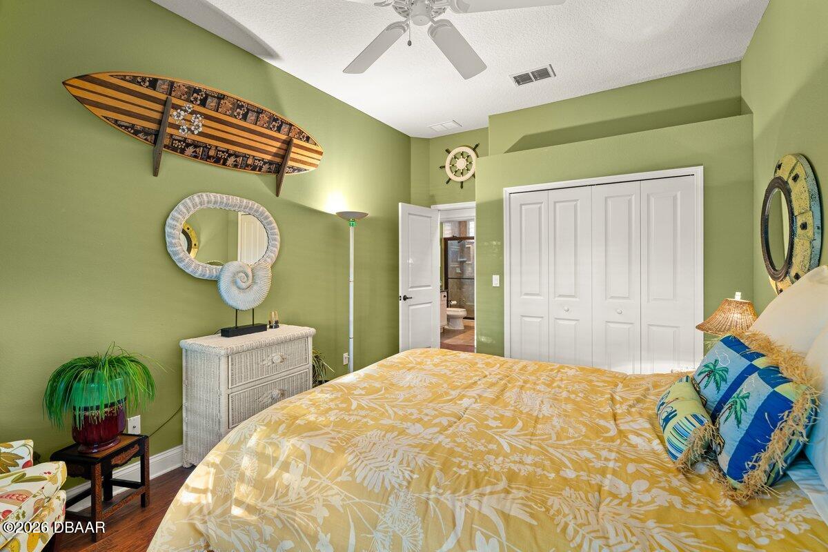 4767 Riverglen Boulevard Ponce Inlet, FL 32127 - Photo 51 of 60 a bedroom with a bed dresser and a window