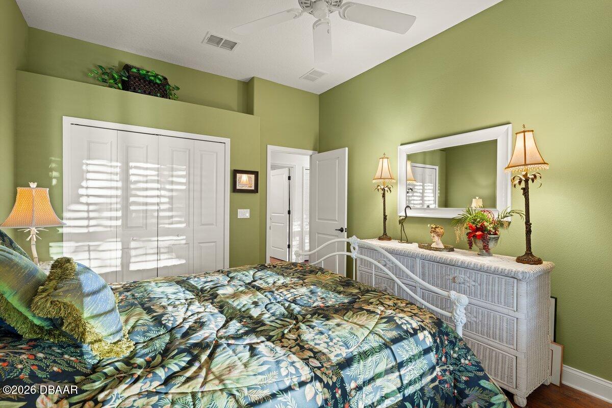 4767 Riverglen Boulevard Ponce Inlet, FL 32127 - Photo 55 of 60 a bedroom with a bed dresser and a window