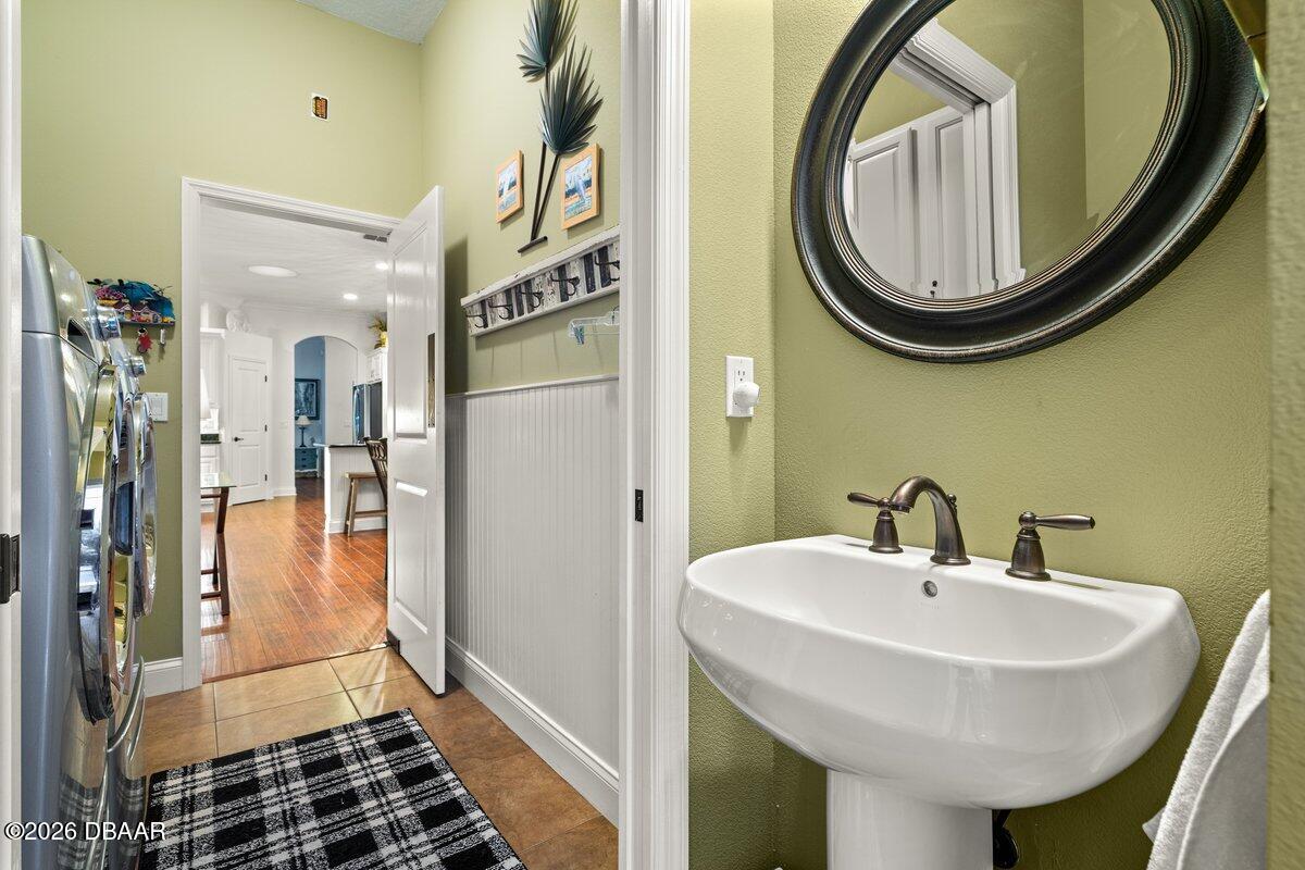 4767 Riverglen Boulevard Ponce Inlet, FL 32127 - Photo 56 of 60 a bathroom with a sink and a mirror