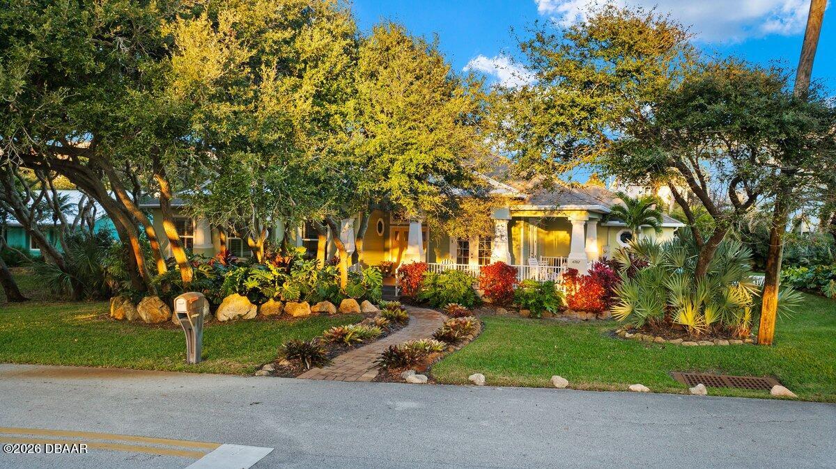 4767 Riverglen Boulevard Ponce Inlet, FL 32127 - Photo 8 of 60 a front view of a house with a yard and tree s