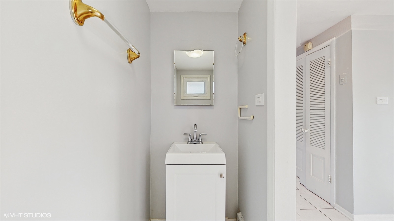 7700 Maple Street Morton Grove, IL 60053 - Photo 12 of 43 a bathroom with a sink and a mirror