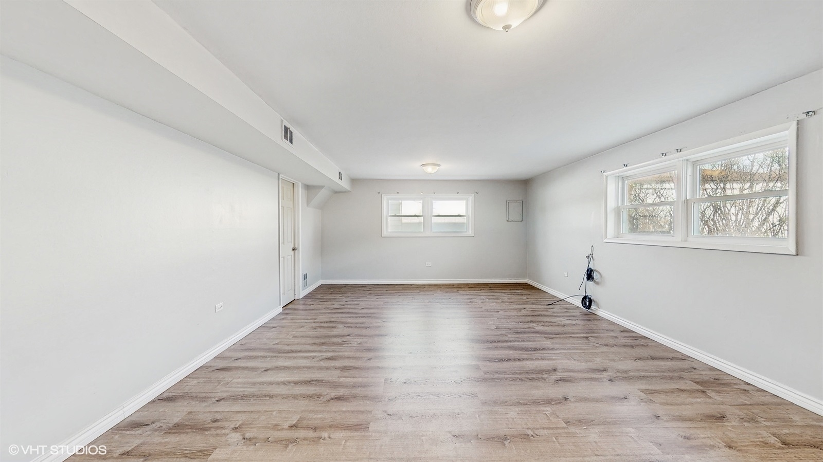 7700 Maple Street Morton Grove, IL 60053 - Photo 13 of 43 an empty room with wooden floor and windows