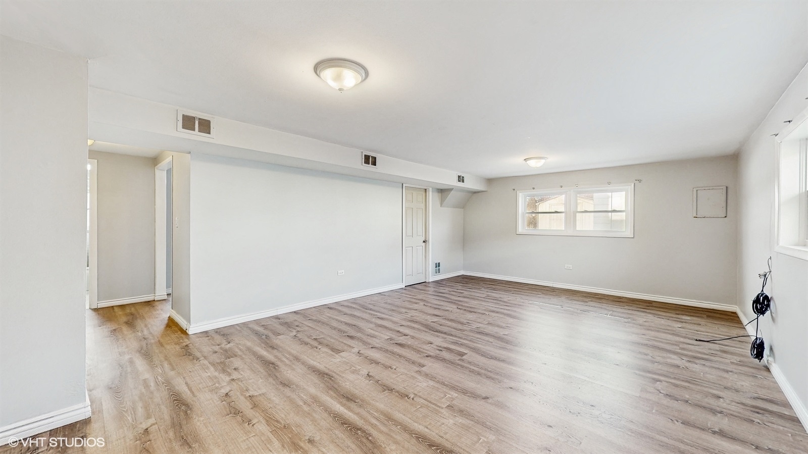 7700 Maple Street Morton Grove, IL 60053 - Photo 15 of 43 a view of empty room with wooden floor and fan