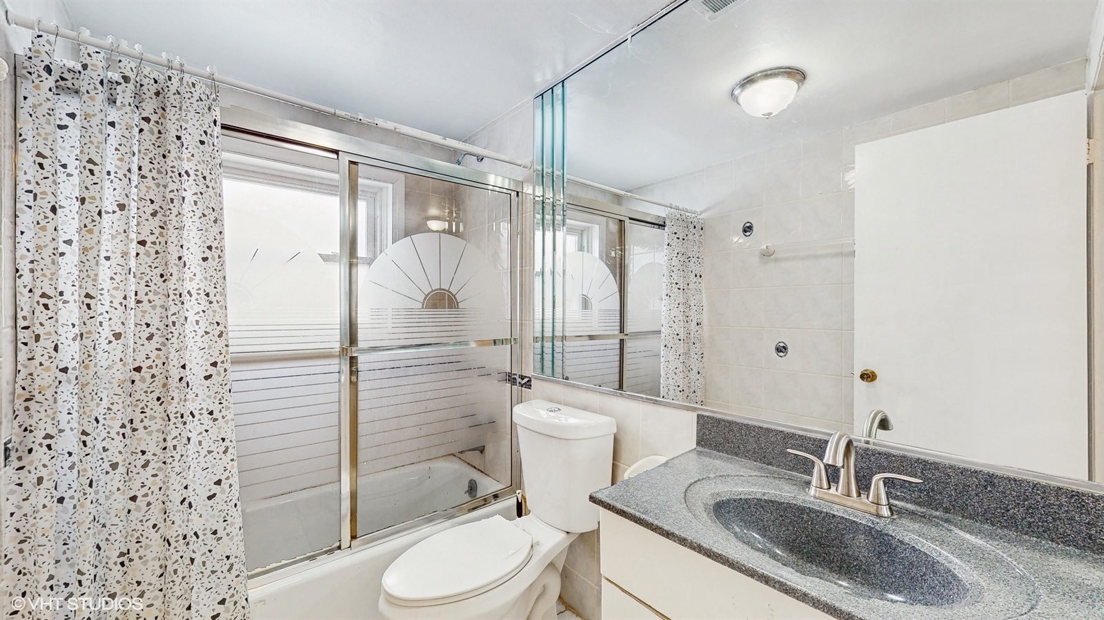 7700 Maple Street Morton Grove, IL 60053 - Photo 19 of 43 a bathroom with a granite countertop sink toilet and shower