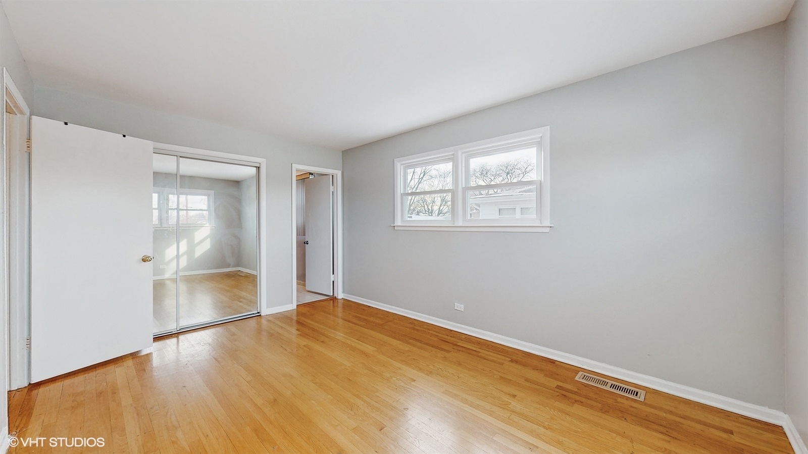 7700 Maple Street Morton Grove, IL 60053 - Photo 23 of 43 an empty room with wooden floor and windows