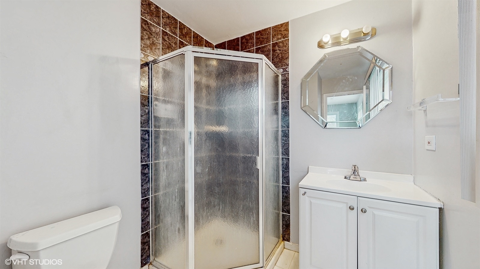 7700 Maple Street Morton Grove, IL 60053 - Photo 24 of 43 a bathroom with a shower and mirror