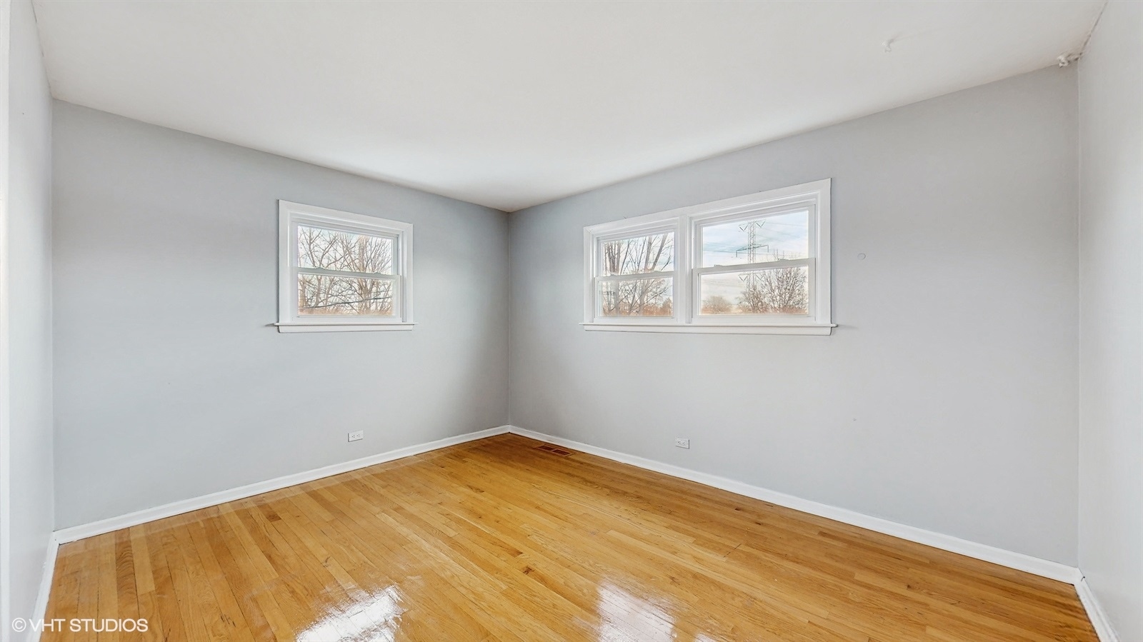 7700 Maple Street Morton Grove, IL 60053 - Photo 28 of 43 a view of a room with wooden floor and windows