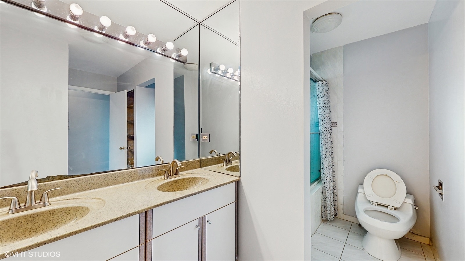7700 Maple Street Morton Grove, IL 60053 - Photo 34 of 43 a bathroom with a granite countertop sink a toilet and a mirror