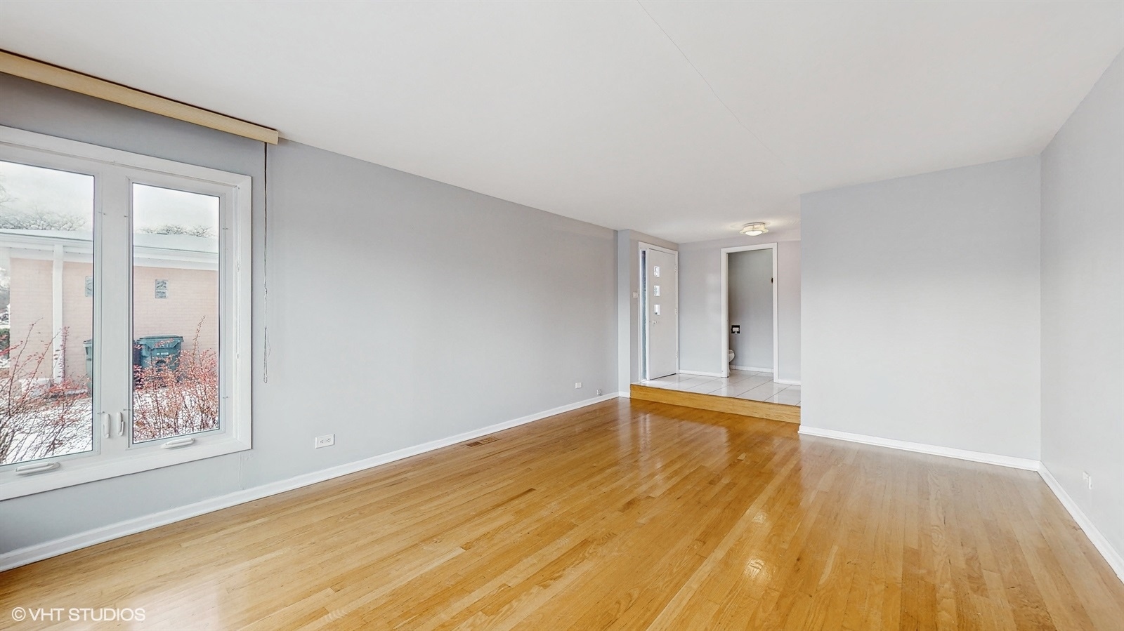 7700 Maple Street Morton Grove, IL 60053 - Photo 5 of 43 a view of room with window and wooden floor