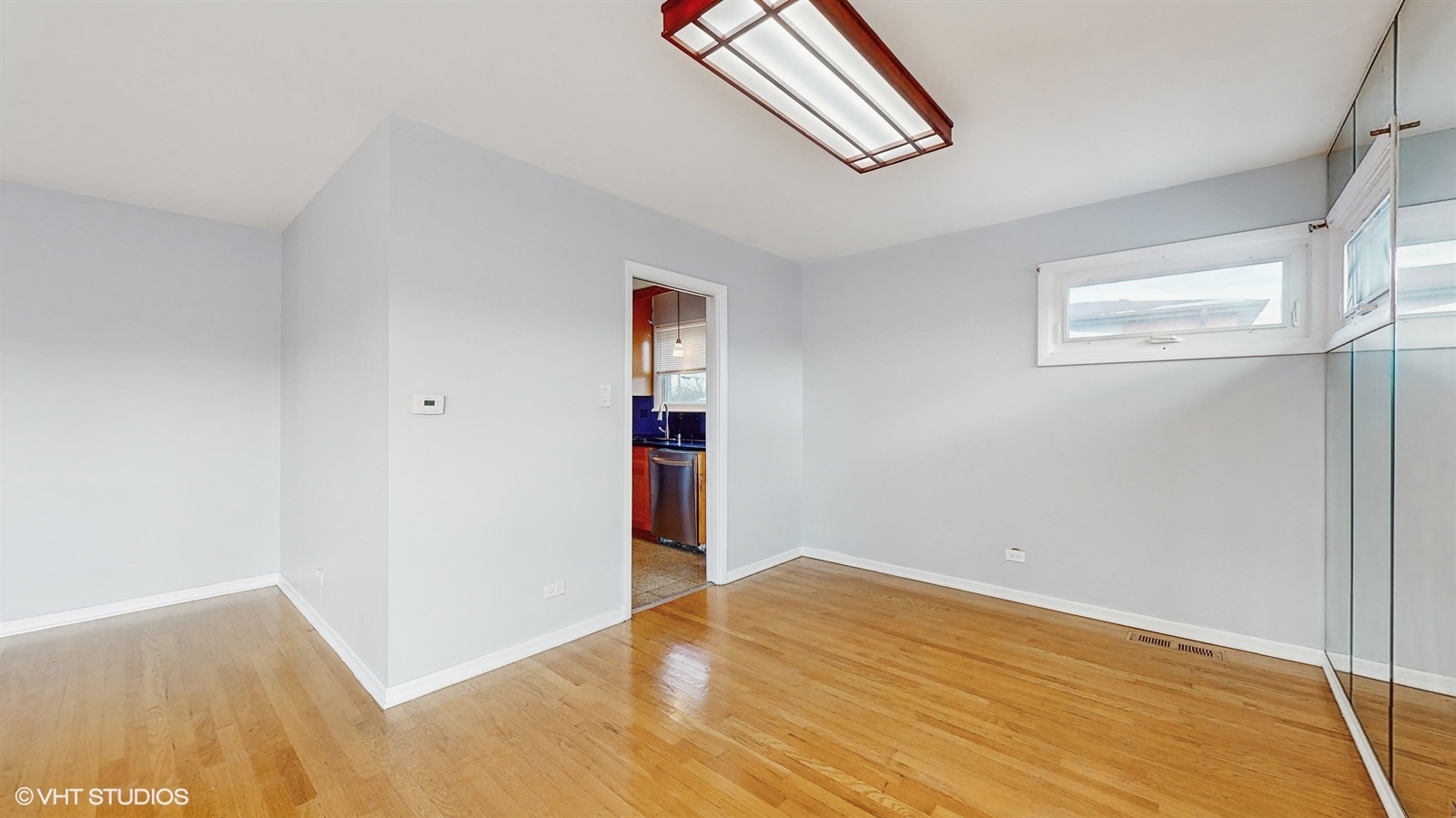 7700 Maple Street Morton Grove, IL 60053 - Photo 6 of 43 a view of empty room with wooden floor