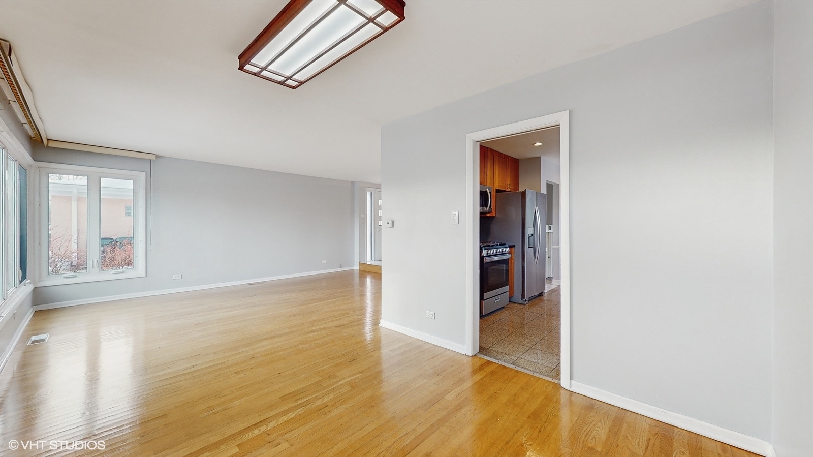 7700 Maple Street Morton Grove, IL 60053 - Photo 7 of 43 a view of an empty room with wooden floor
