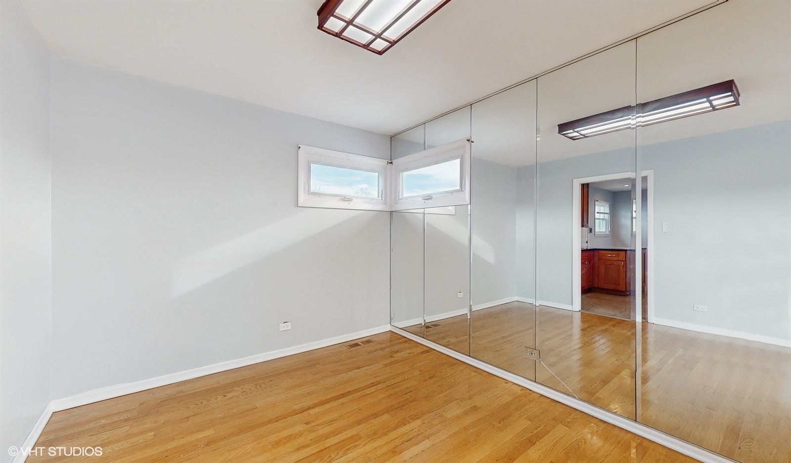 7700 Maple Street Morton Grove, IL 60053 - Photo 8 of 43 a view of a room with wooden floor