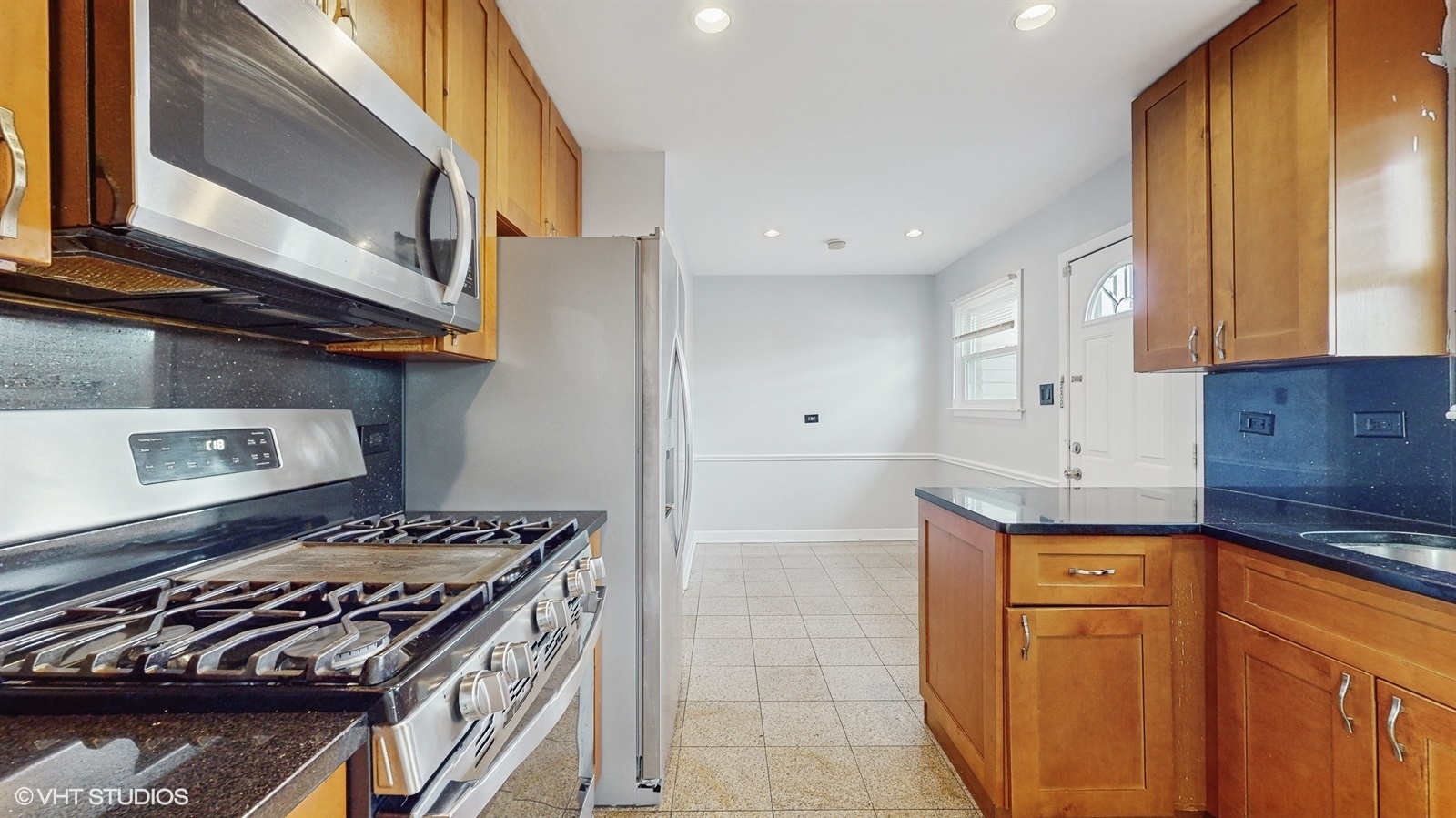 7700 Maple Street Morton Grove, IL 60053 - Photo 9 of 43 a kitchen with stainless steel appliances granite countertop a stove and a refrigerator