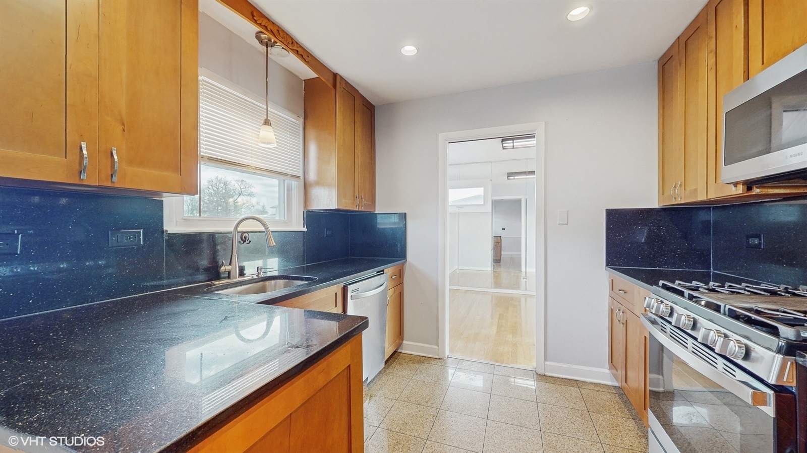 7700 Maple Street Morton Grove, IL 60053 - Photo 10 of 43 a kitchen with stainless steel appliances granite countertop a sink and a stove