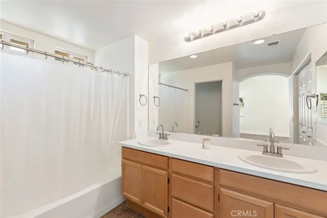 a bathroom with a double vanity sink mirror and double