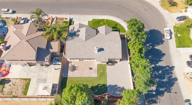 an aerial view of a house with a yard and garden