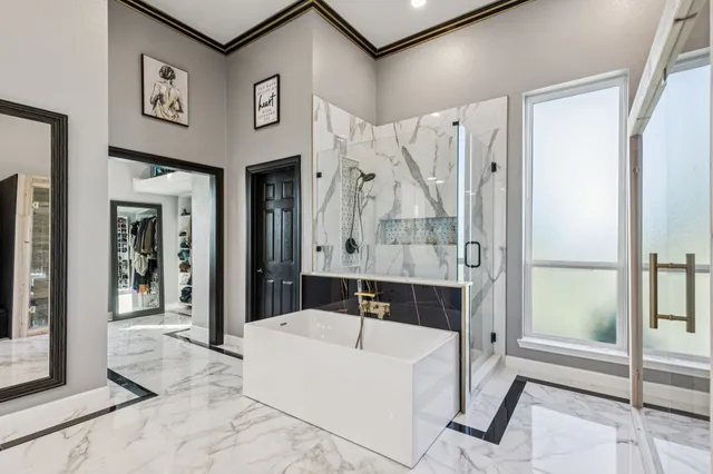 a bathroom with a bathtub and a shower