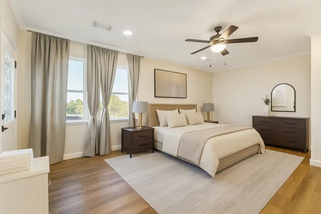 a bedroom with a large bed and a chandelier