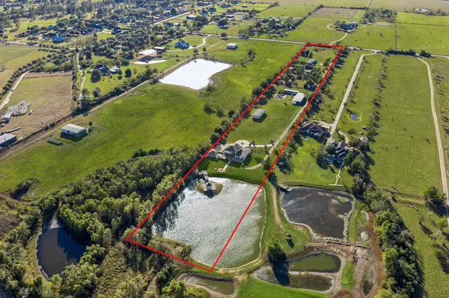 an aerial view of a residential houses with outdoor space