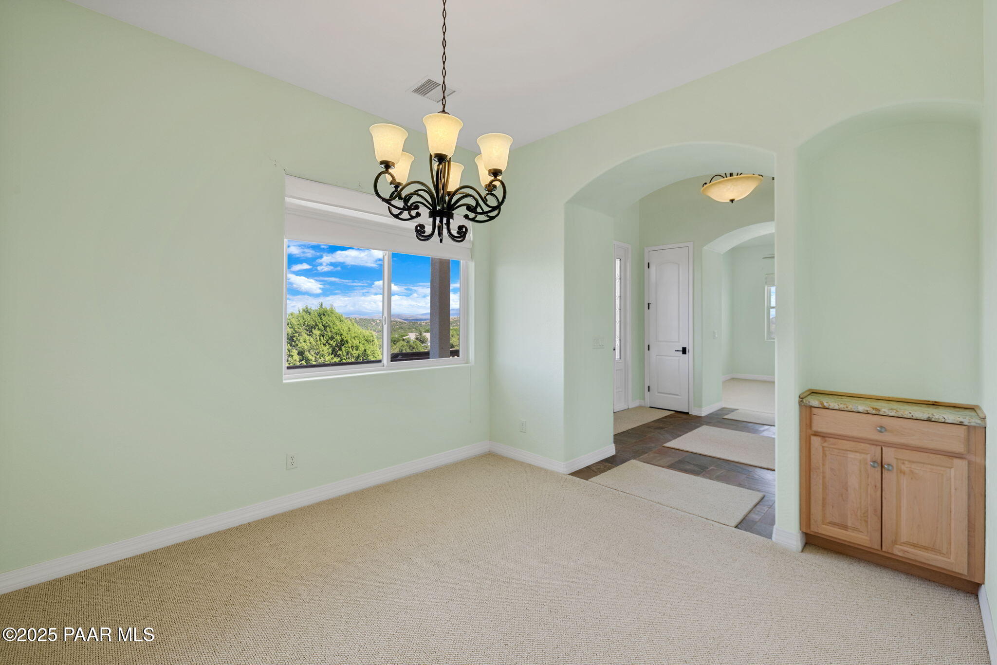 5370 North Skyhawk Road Chino Valley, AZ 86323 - Photo 11 of 25 a view of a livingroom with a chandelier furniture and windows