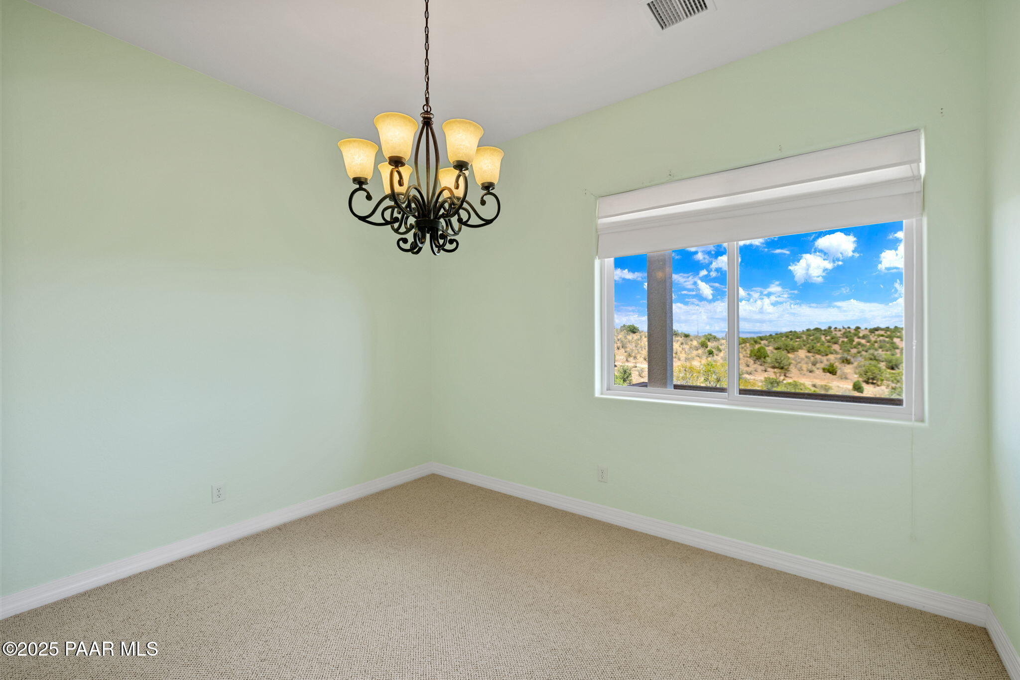 5370 North Skyhawk Road Chino Valley, AZ 86323 - Photo 12 of 25 a view of empty room with window and chandelier