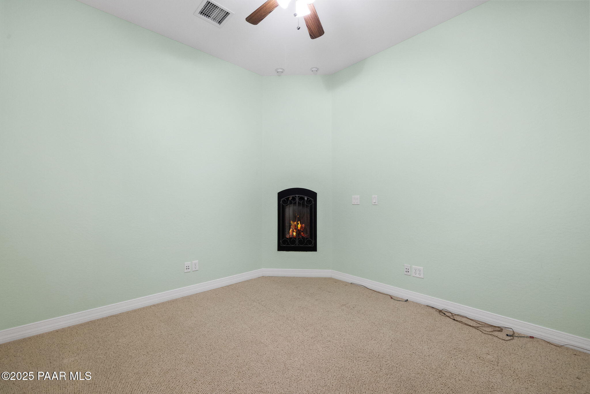5370 North Skyhawk Road Chino Valley, AZ 86323 - Photo 15 of 25 an empty room with a ceiling fan and wooden floor