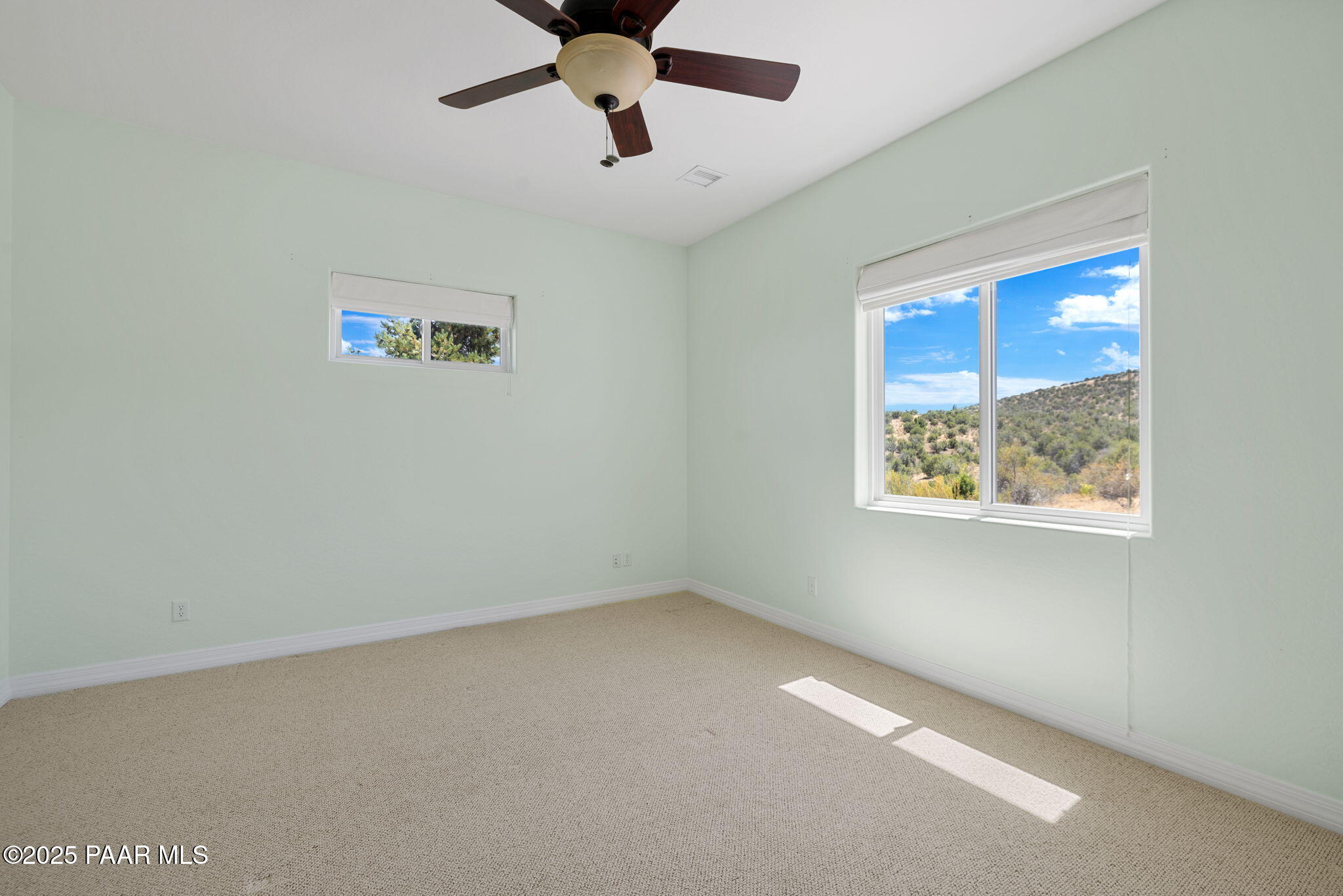 5370 North Skyhawk Road Chino Valley, AZ 86323 - Photo 21 of 25 an empty room with a window and a ceiling fan
