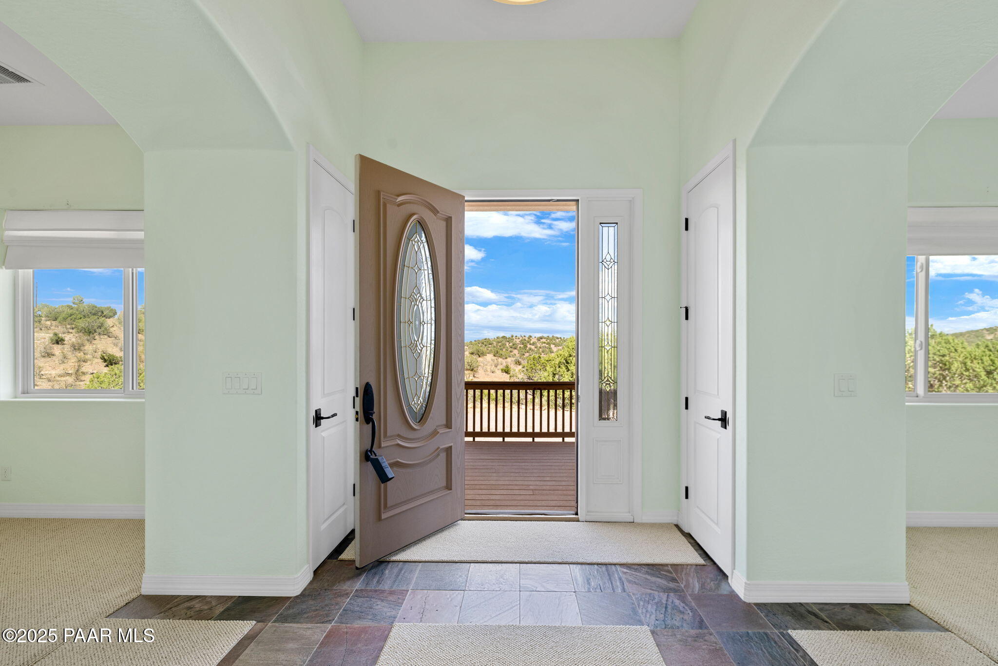 5370 North Skyhawk Road Chino Valley, AZ 86323 - Photo 4 of 25 a view of a hallway with wooden floor and a livingroom