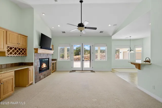 a view of an empty room with a fireplace and a flat screen tv