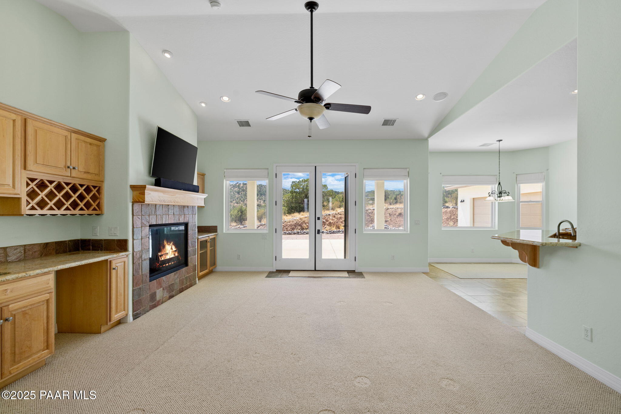 5370 North Skyhawk Road Chino Valley, AZ 86323 - Photo 7 of 25 a view of an empty room with a fireplace and a flat screen tv