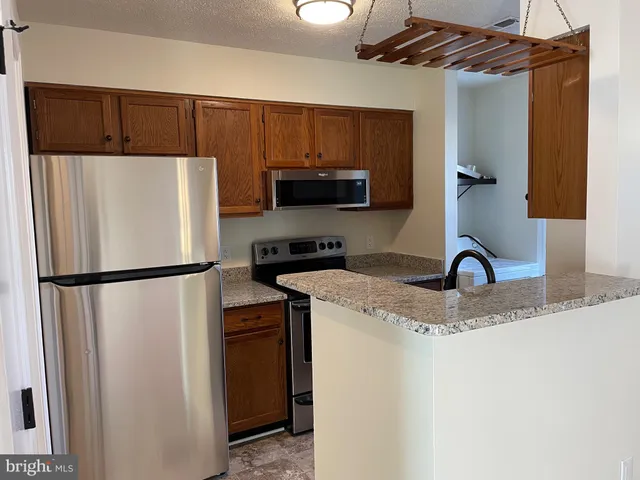a white refrigerator freezer sitting inside of a kitchen