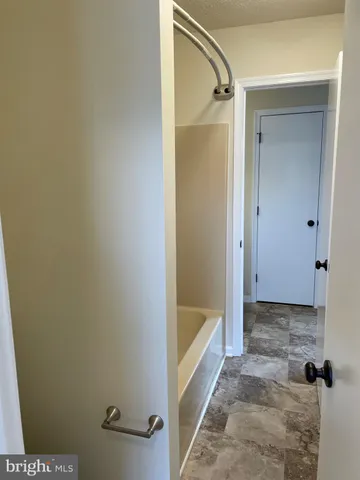 a bathroom with a tub and shower