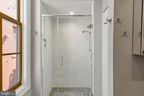 a bathroom with a glass shower door