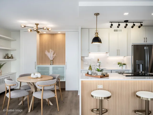 a dining room with furniture and a chandelier
