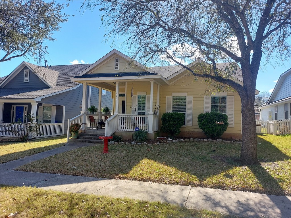 a view of a house with backyard porch and sitting area