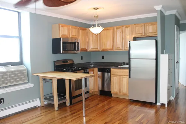 a kitchen with wooden cabinets and refrigerator