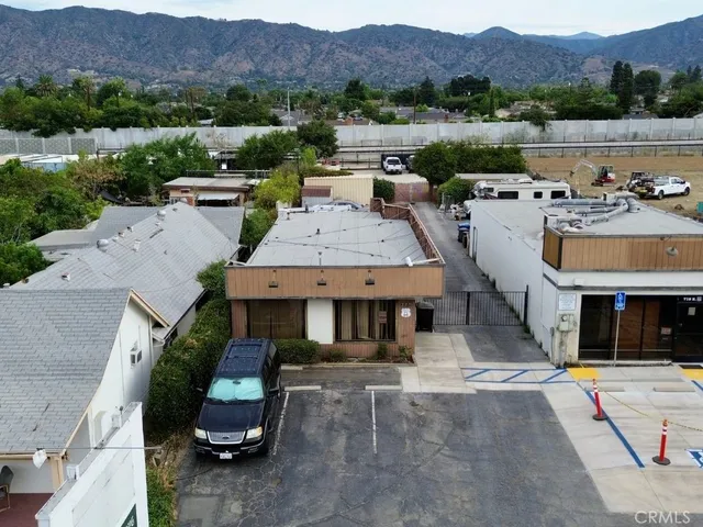 an aerial view of a house with pool and a yard
