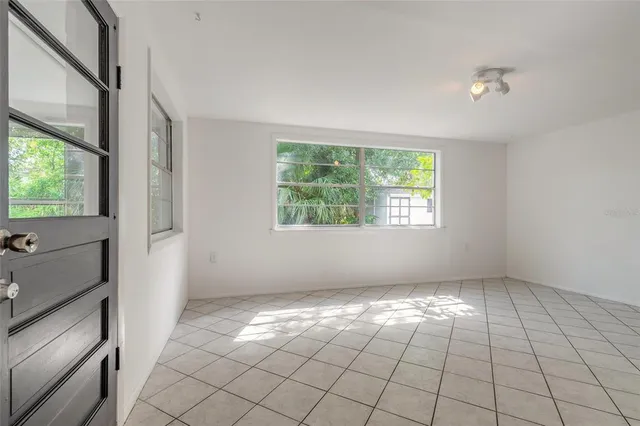 an empty room with windows and closet