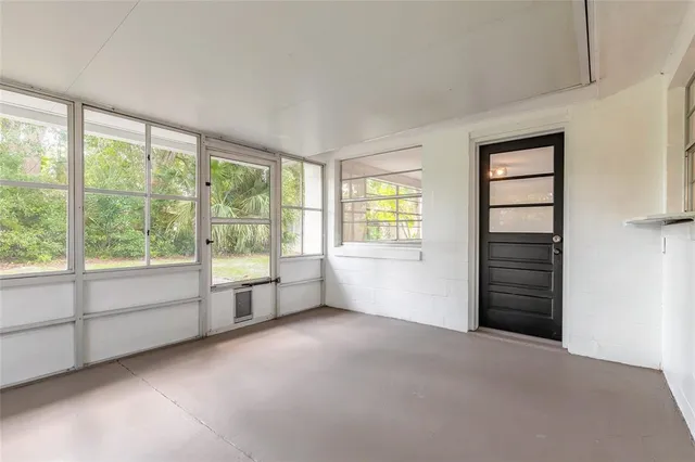 an empty room with a empty space and windows